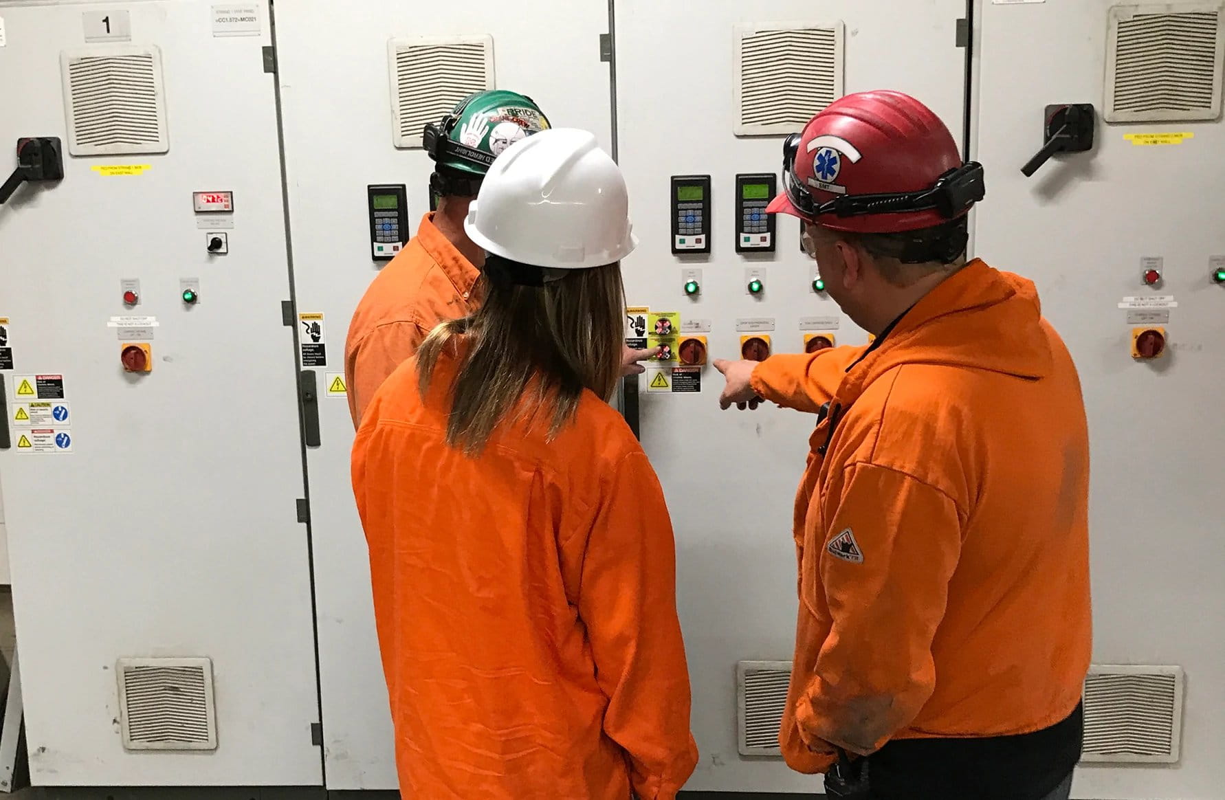 Employees checking on cabinets and controls