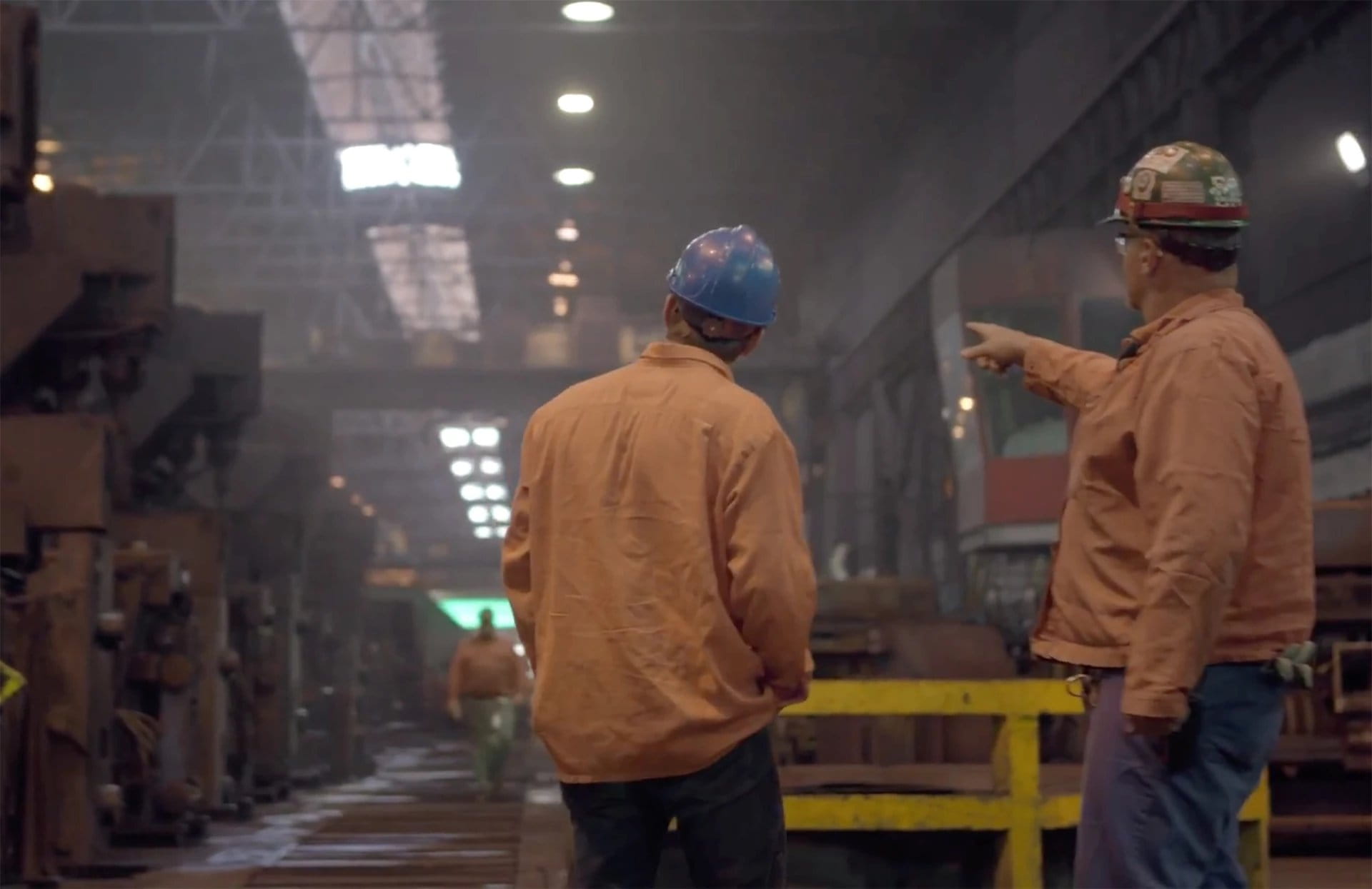 Manufacturing Partners in an industrial plant working together.