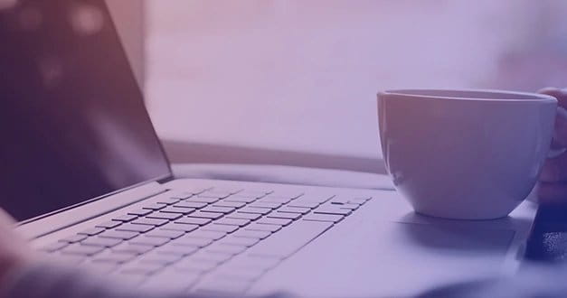 Cup of coffee and a laptop with blue purple overlay for online training hero.
